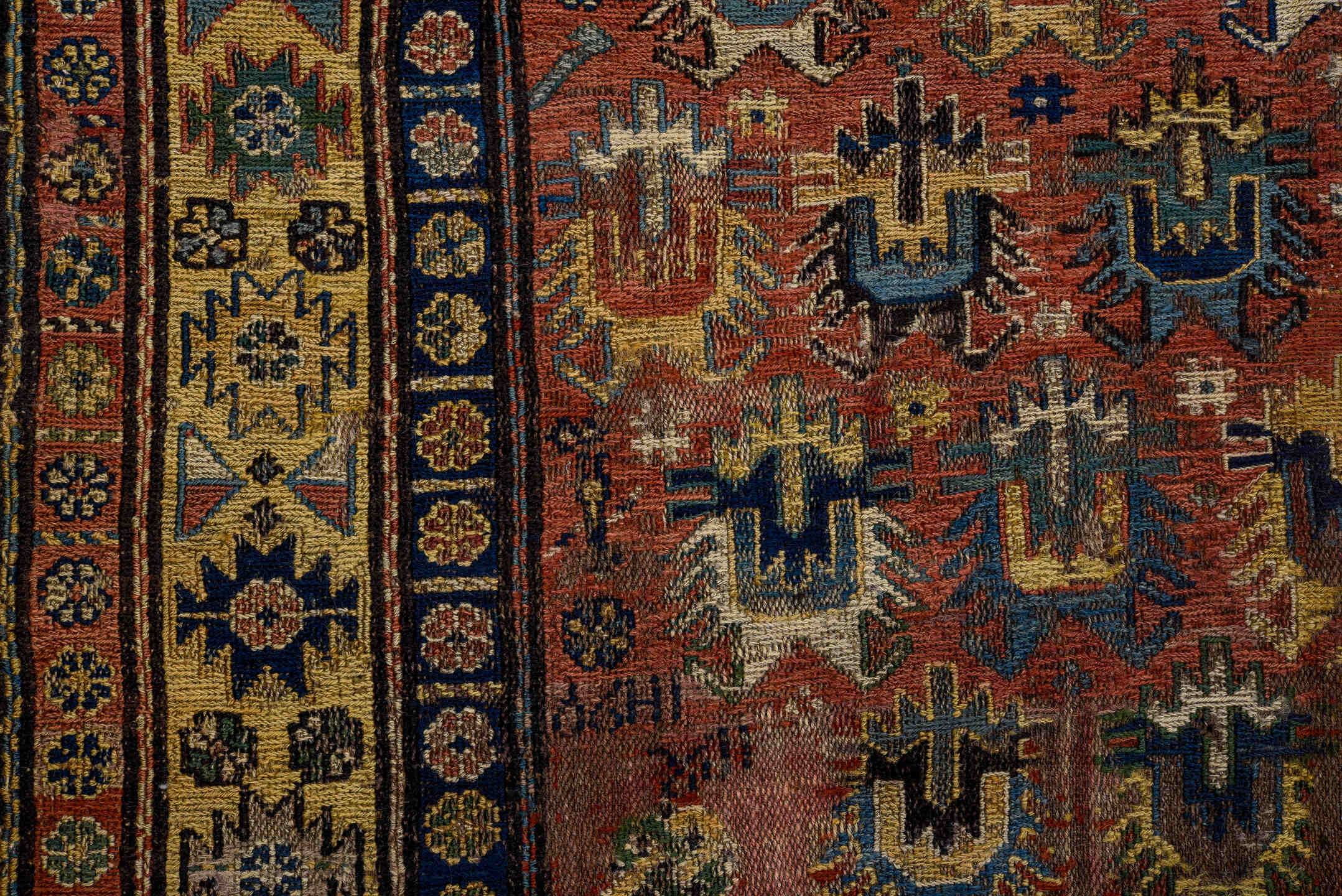 3' x 7' one-of-a-kind handmade vintage Sumak rug. Color palette: brown, yellow, blue, gray, off-white, red, orange, arapawa