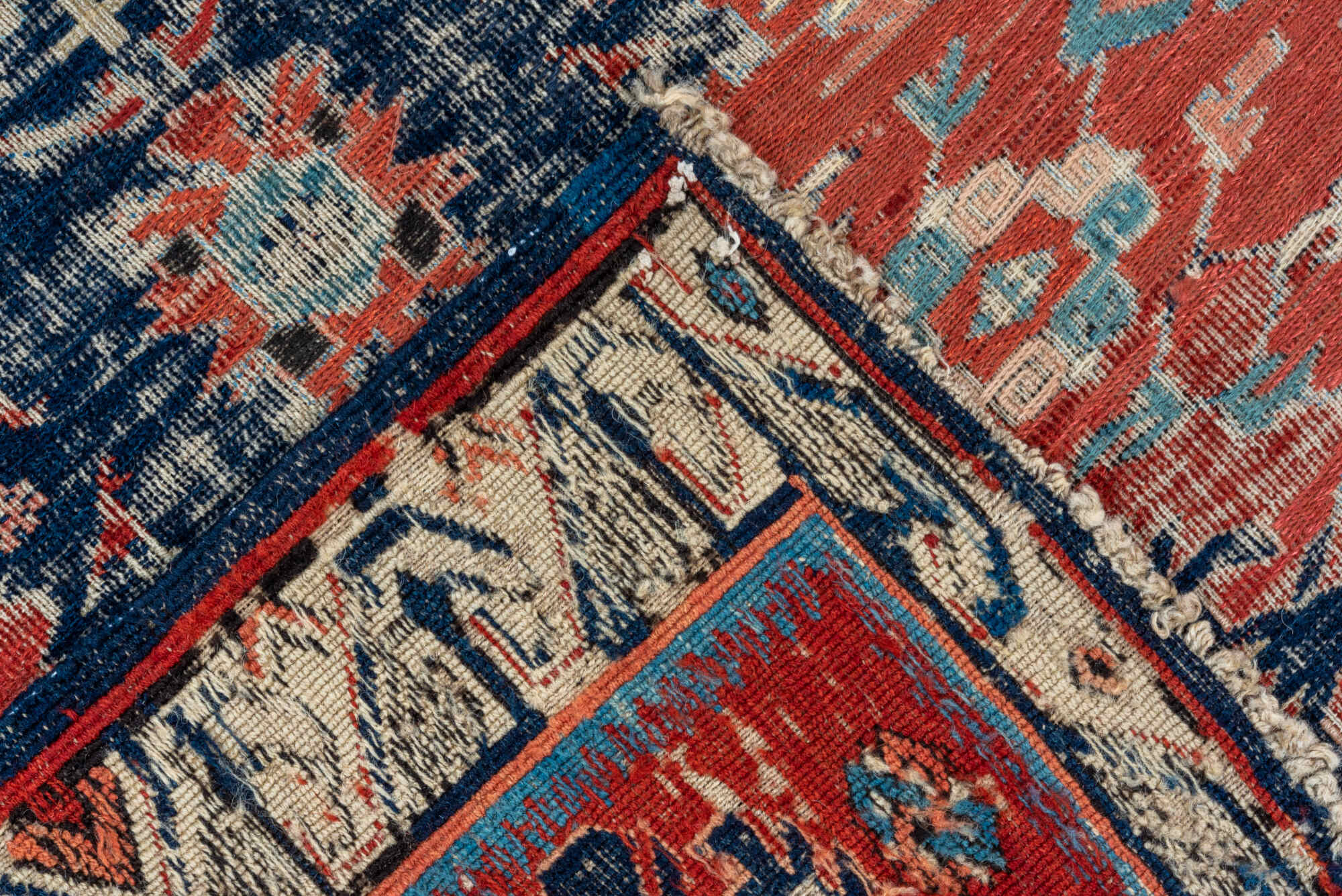 5' x 7' one-of-a-kind handmade vintage Sumak rug. Color palette: black, blue, brown, charcoal, dark gray, gray, pink, red