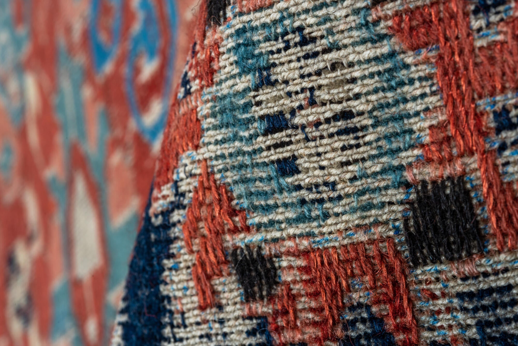 5' x 7' one-of-a-kind handmade vintage Sumak rug. Color palette: black, blue, brown, charcoal, dark gray, gray, pink, red