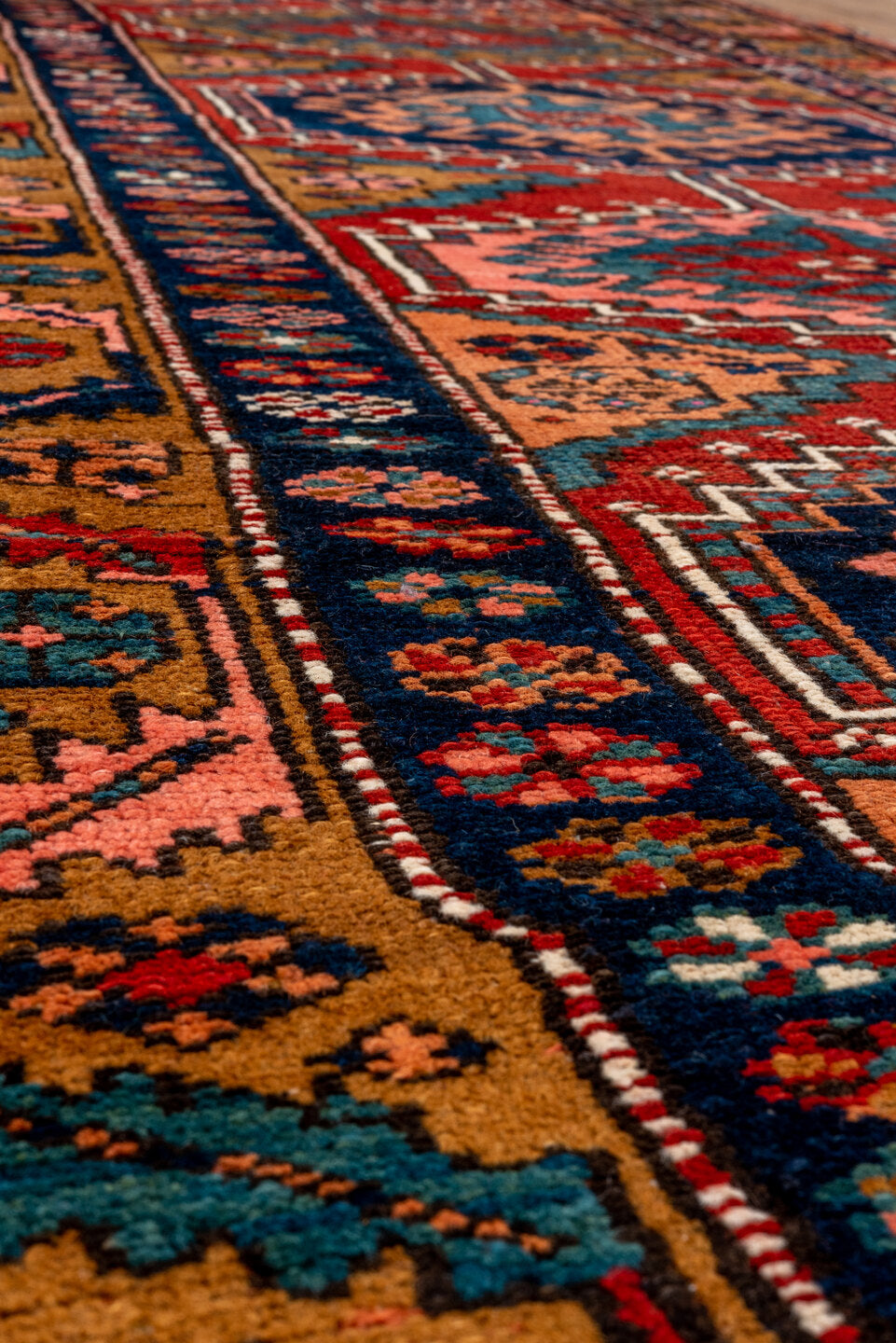 3' x 12' one-of-a-kind handmade vintage Heriz runner rug. Color palette: brown, red, gray, pink, black, blue, maroon