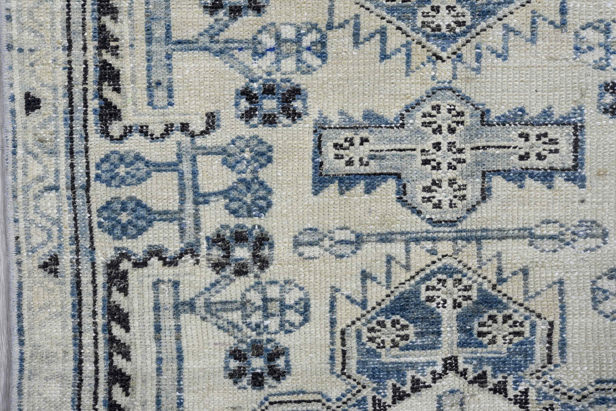 2' x 9' one-of-a-kind handmade vintage Karaje runner rug. Color palette: gray, light gray, off-white, black, blue, silver