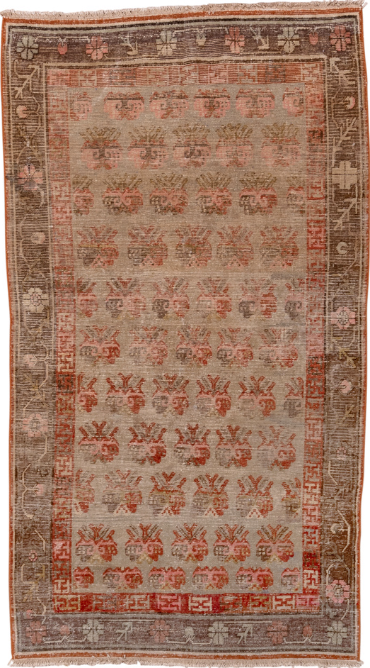 4' x 7' one-of-a-kind handmade vintage Khotan rug. Color palette: brown, pink, off-white, orange