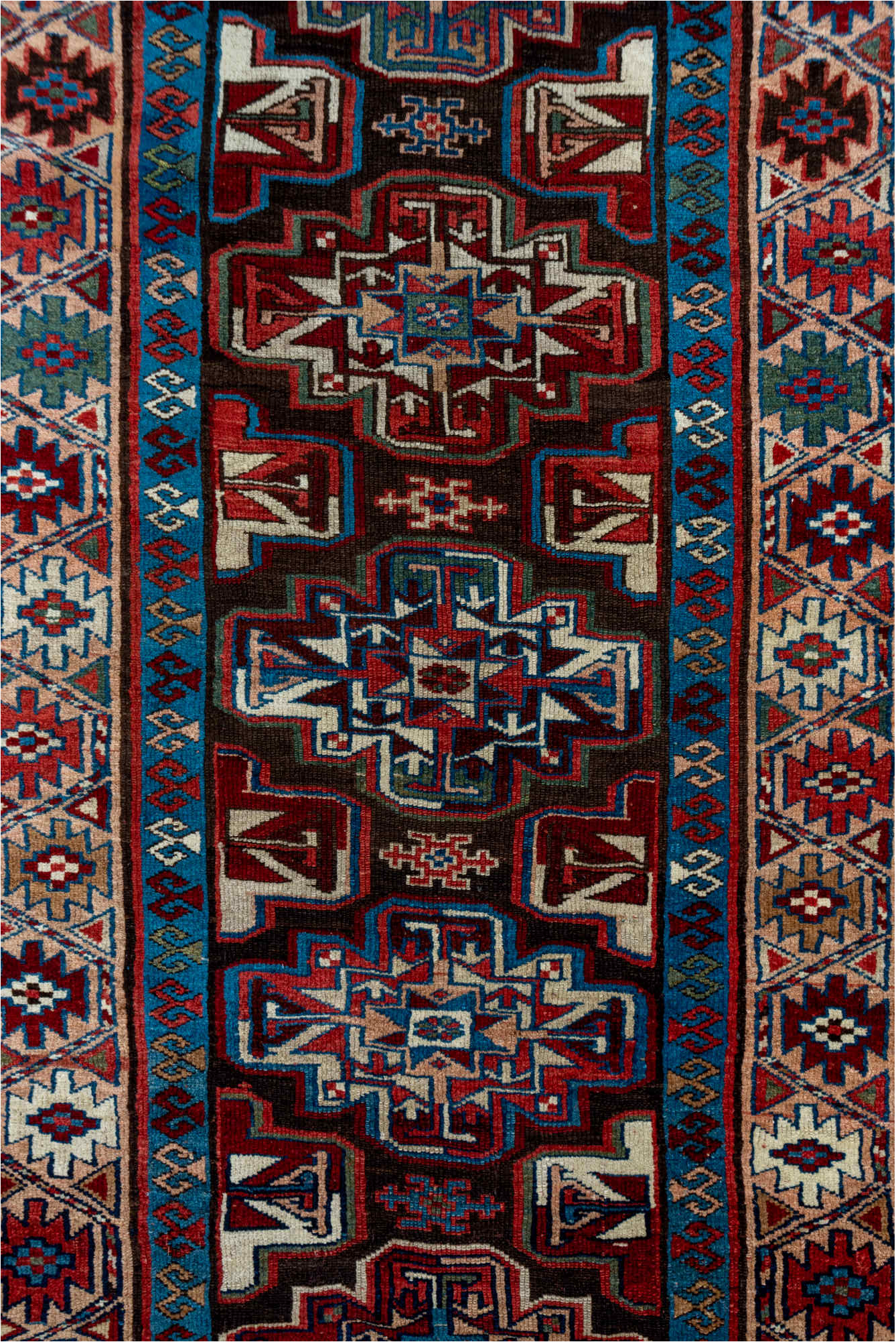 3' x 10' one-of-a-kind handmade vintage Kurd runner rug. Color palette: black, blue, brown, gray, pink, red