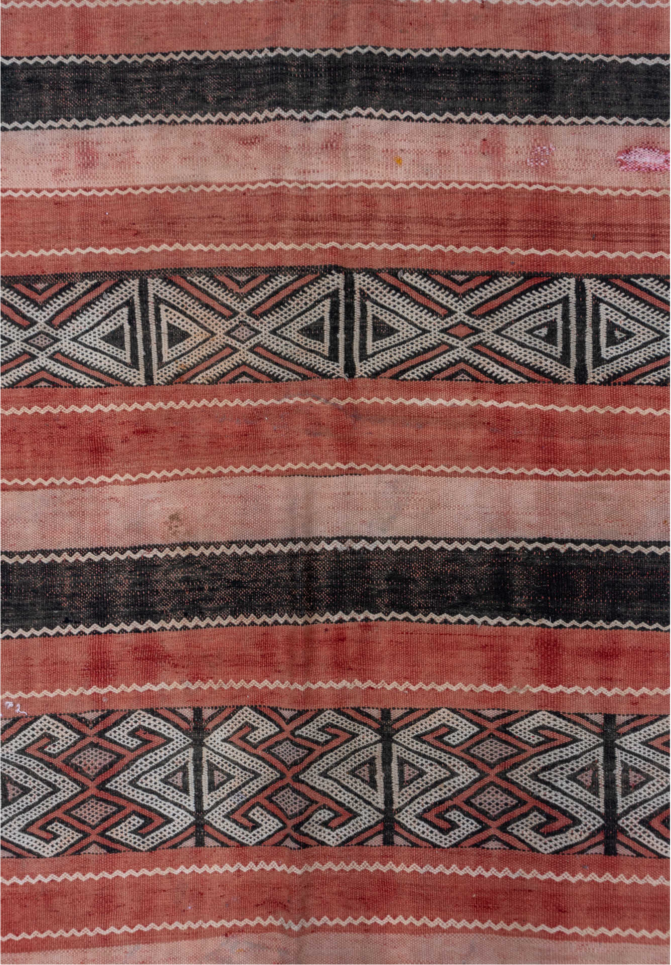 5' x 8' one-of-a-kind handmade vintage Jijim medium size rug. Color palette: black, brown, gray, light gray, orange, pink